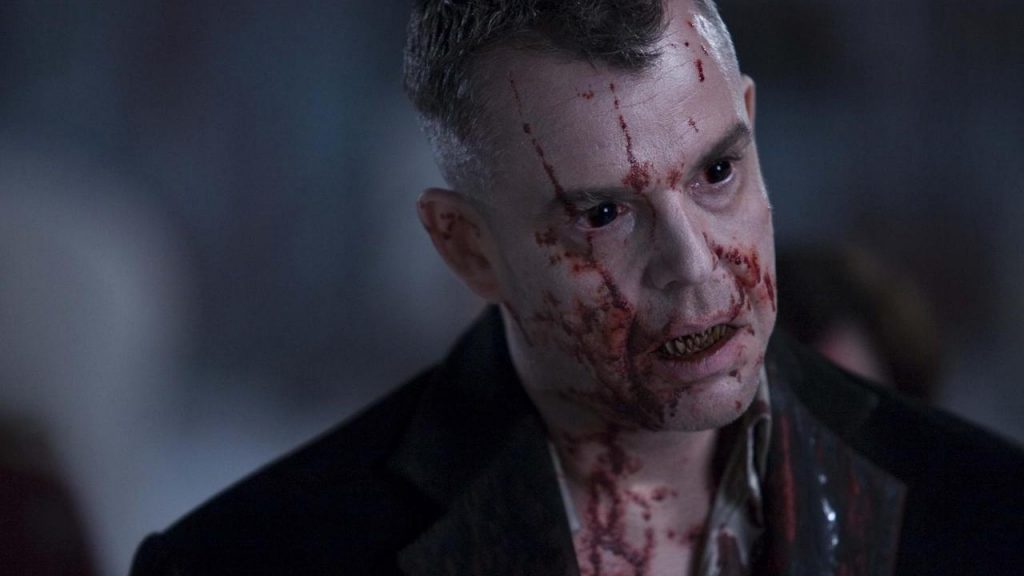 The head vampire with blood all over his face